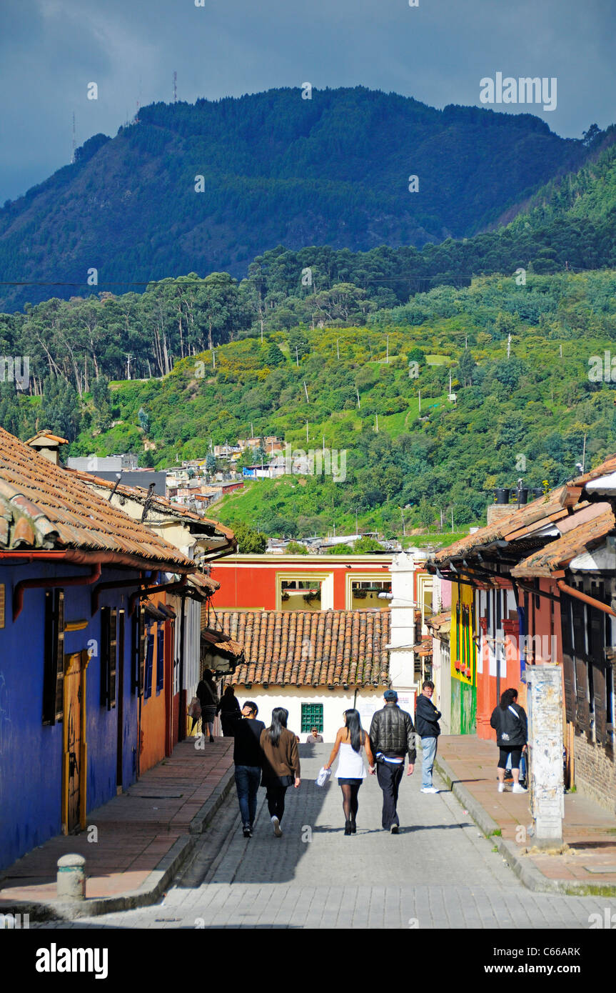 People walking in alleyways at old town, in the back mountains of the cordilleras, La Candelaria quarter, Bogota, Colombia Stock Photo