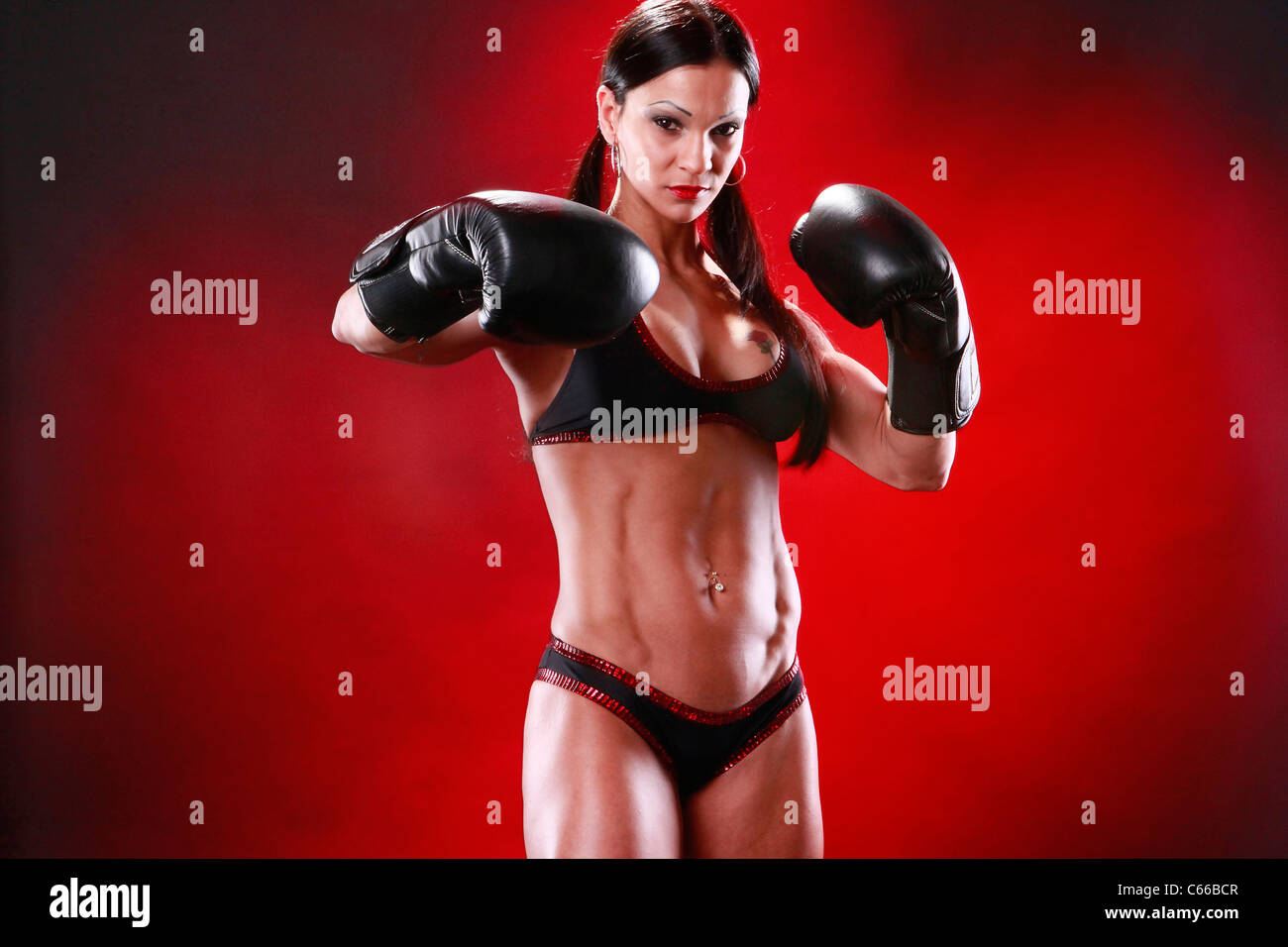 Fit female boxer swings a puch Stock Photo