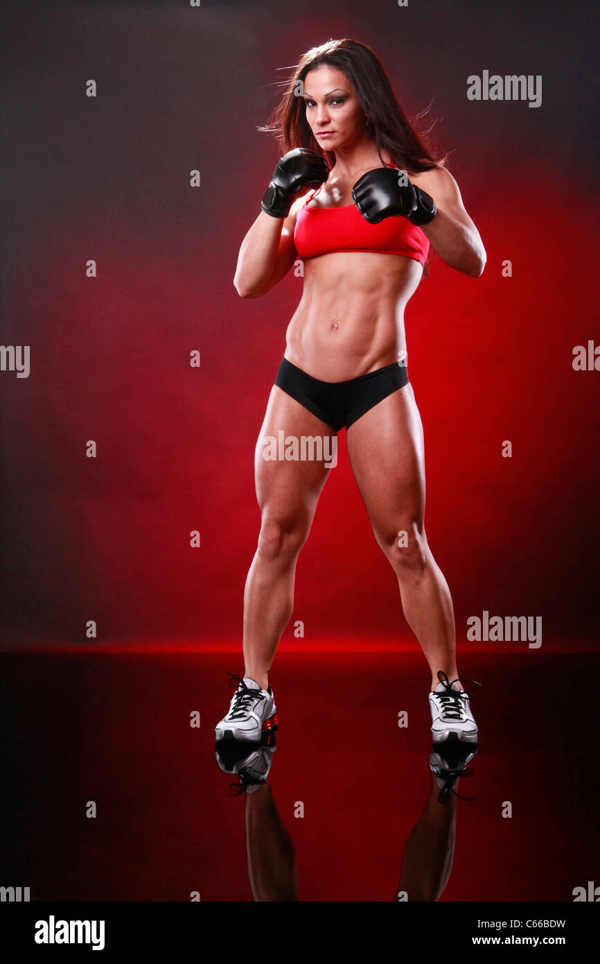 Fit female fighter gloves on Stock Photo