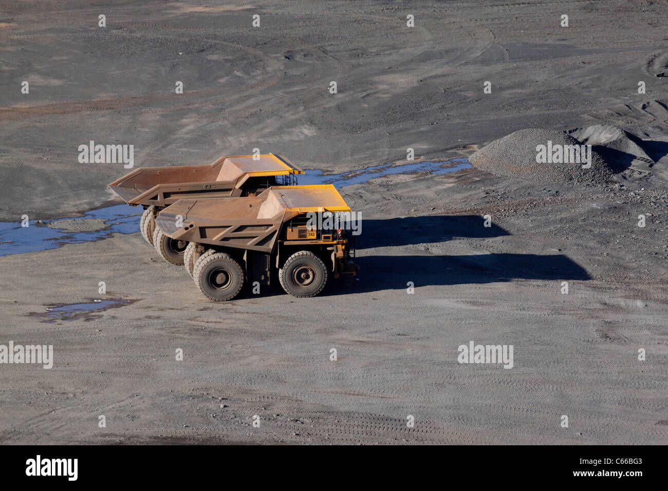 Hull–Rust–Mahoning Open Pit Iron Mine, large haul trucks in evening at bottom of pit Stock Photo