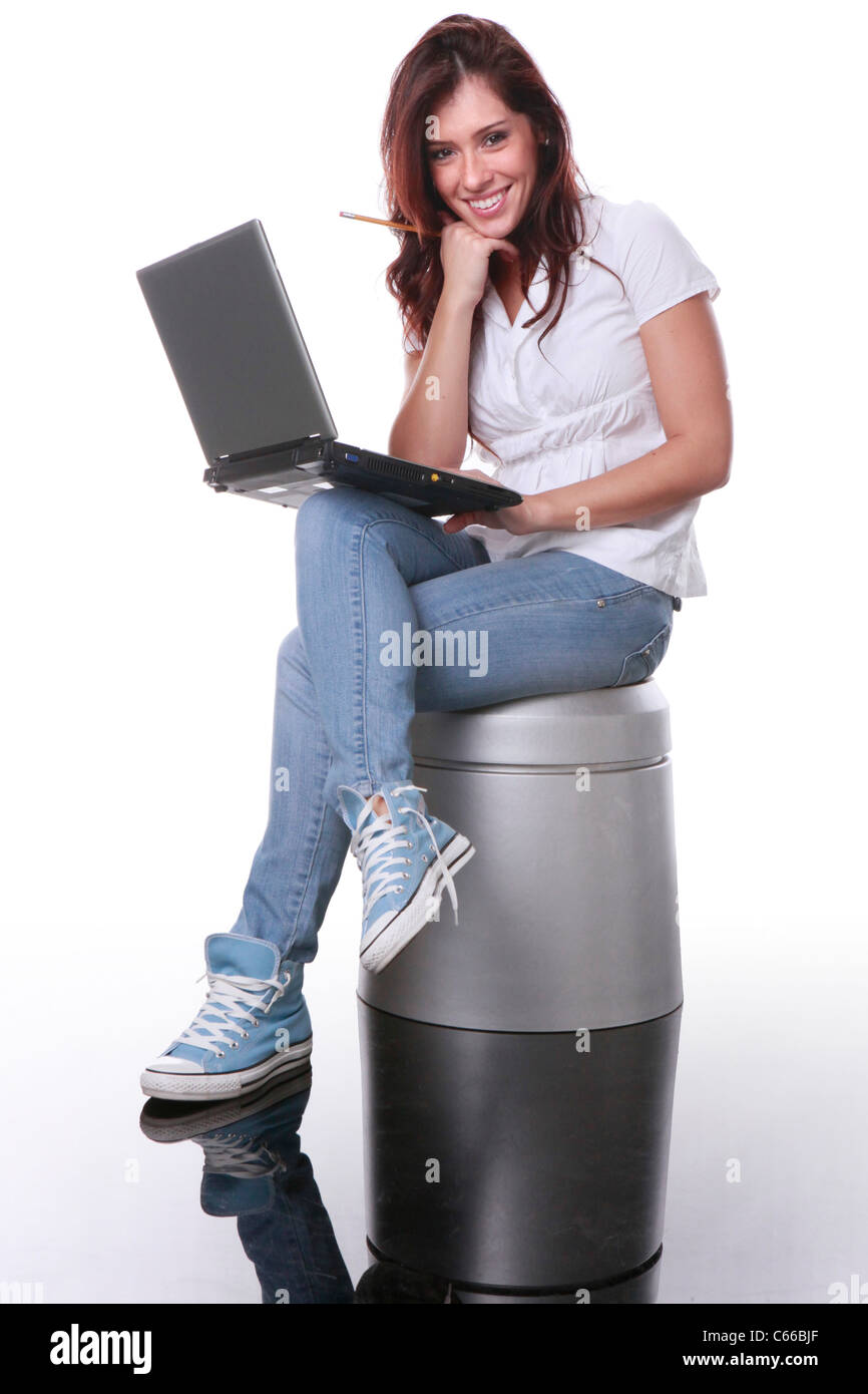 Cute brunette sits with laptop Stock Photo