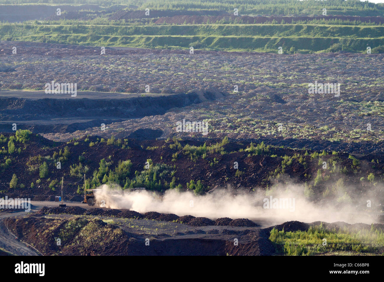 Hull–Rust–Mahoning Open Pit Iron Mine, haul truck kicks up dust on the long trip out of the mine. Stock Photo