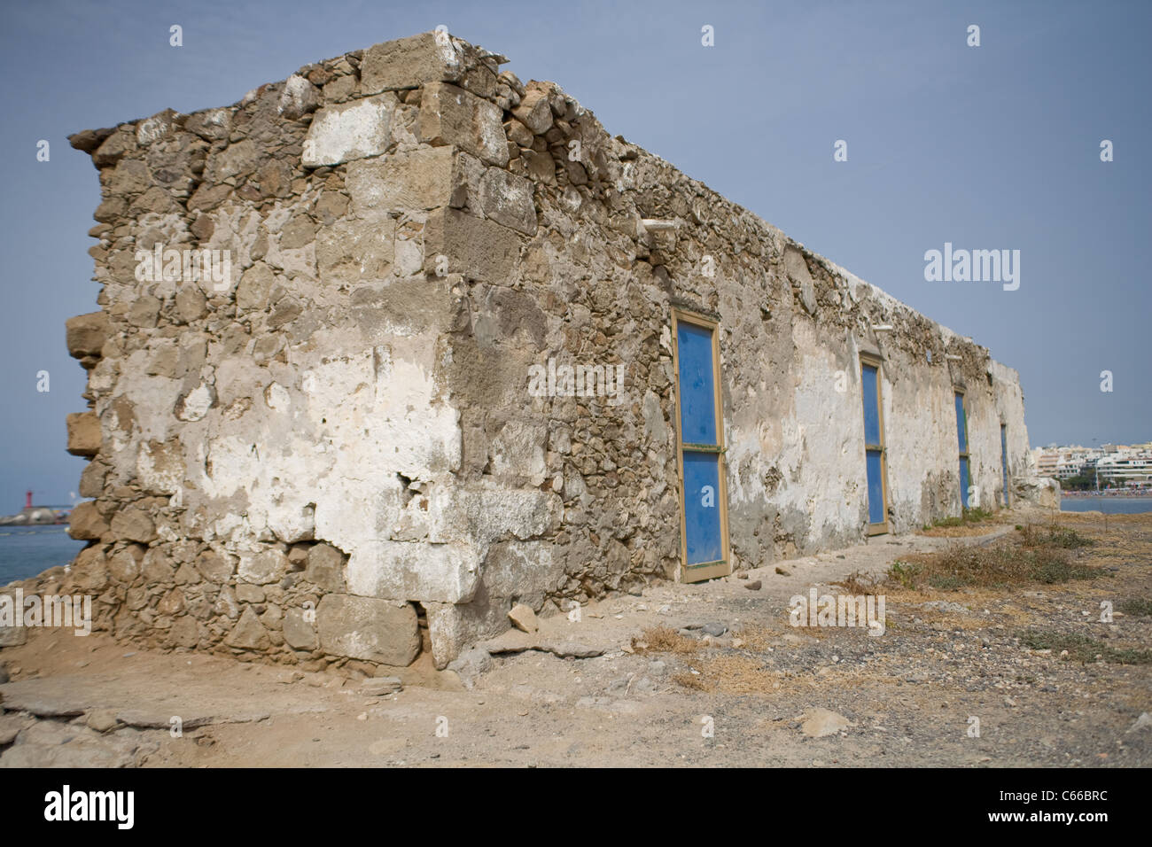 Old derelict building with blue doors and windows Stock Photo