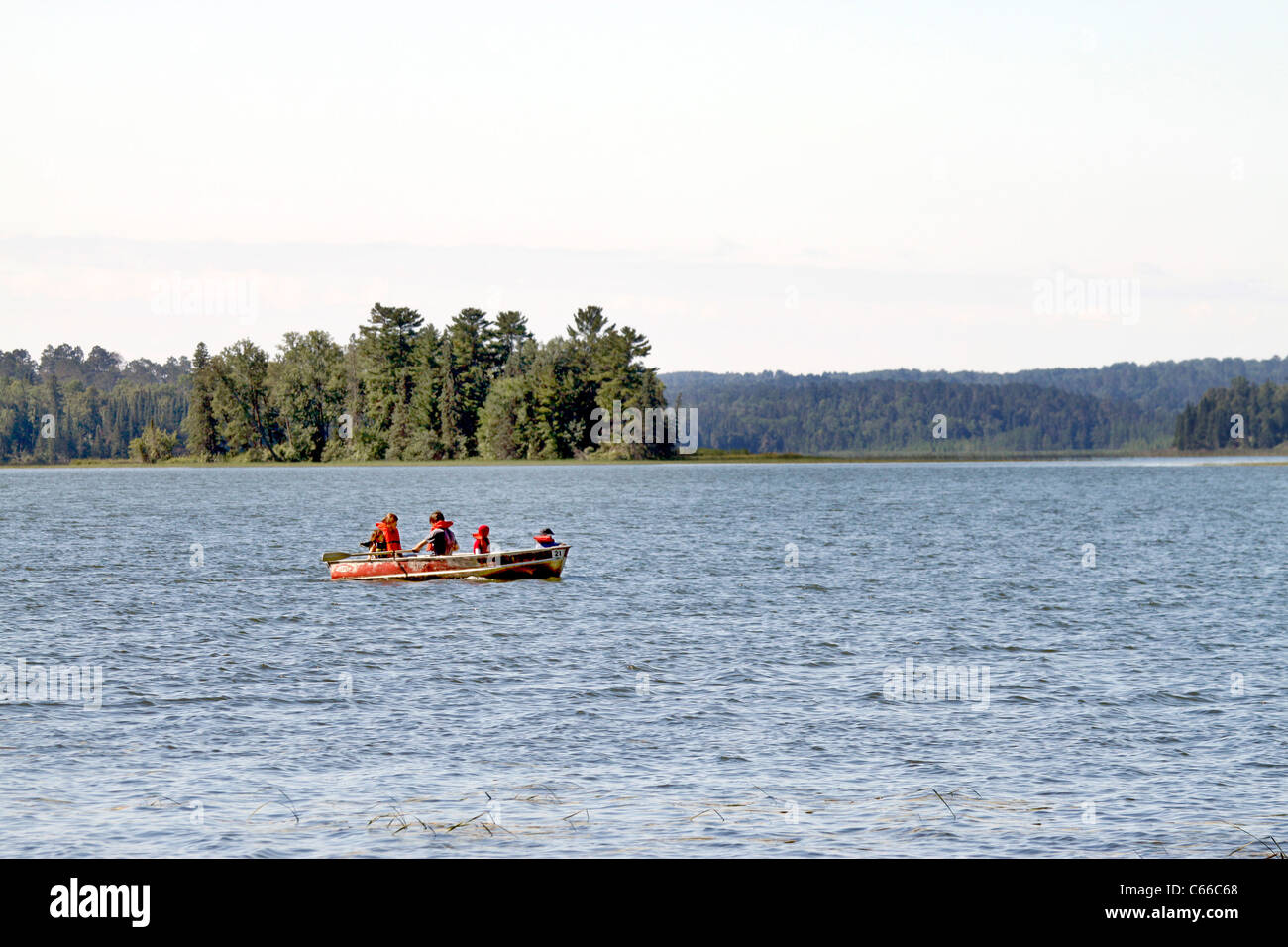 Family boating on East arm Lake Itasca, Itasca State Park headwaters of the Mississippi river in Minnesota Stock Photo