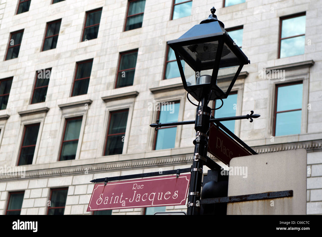 Street sign for Rue Saint-Jacques with lamp post and office windows in the background, old town Montreal, Quebec, Canada Stock Photo