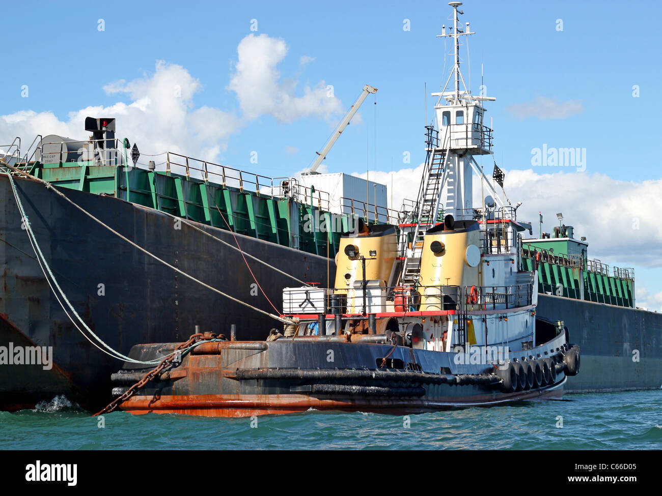 Fuel barge with tug boat in the bay Stock Photo