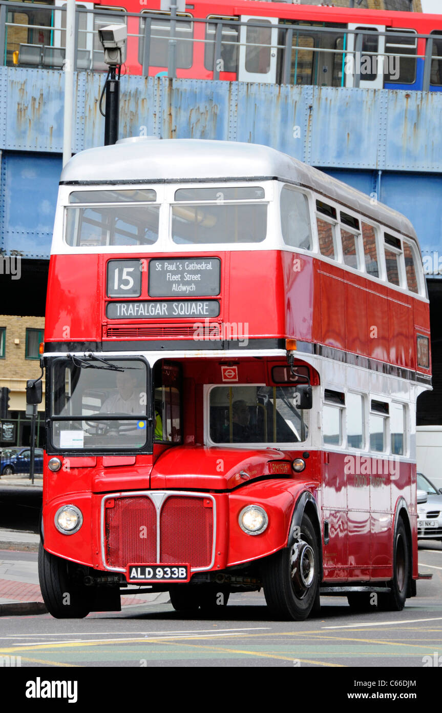 Front view of London Transport public transport red double decker classic historical Routemaster bus & driver in cab on route 15 the heritage route UK Stock Photo