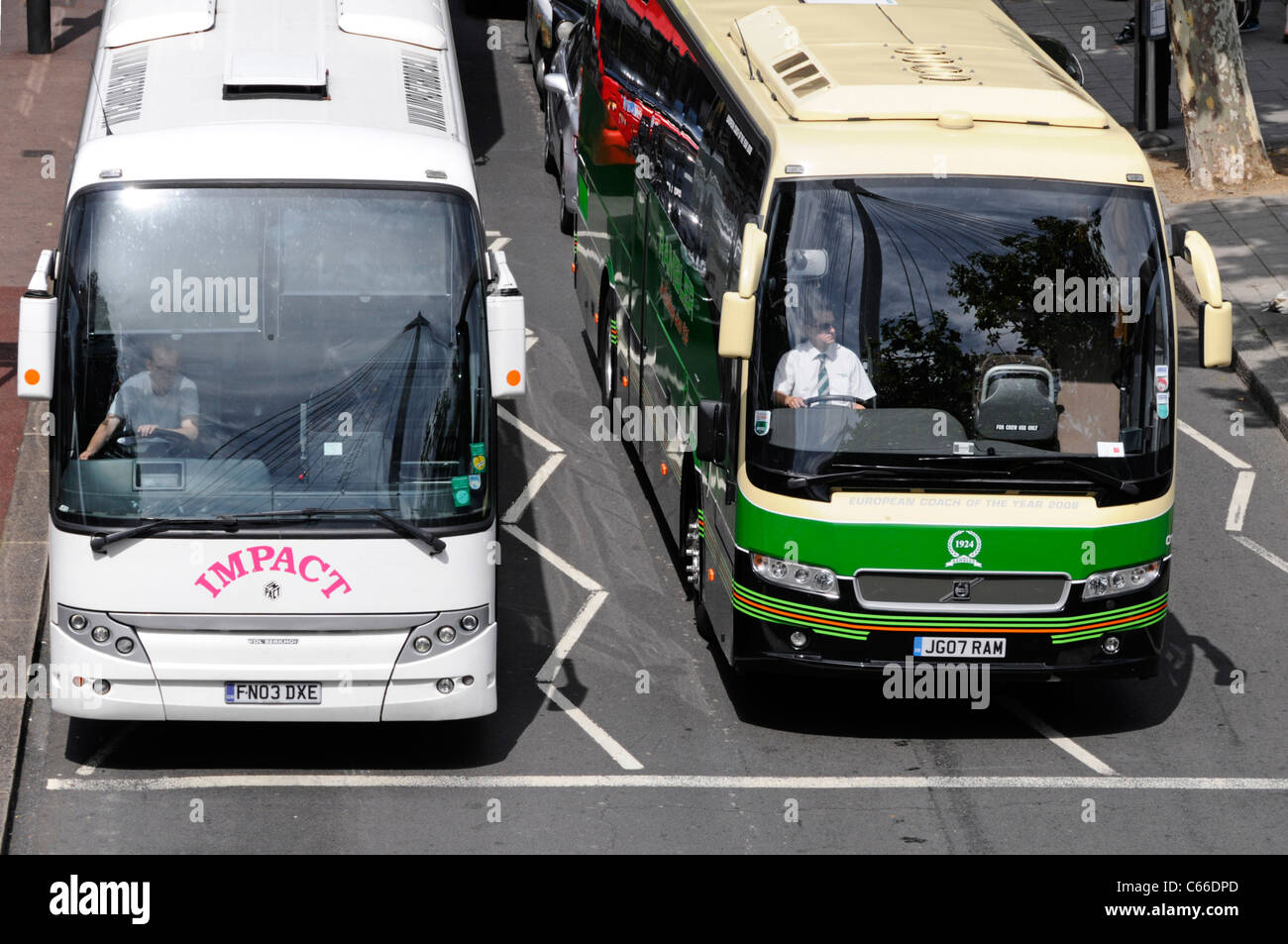 Aerial birds eye view from above looking down at two coach bus drivers ...