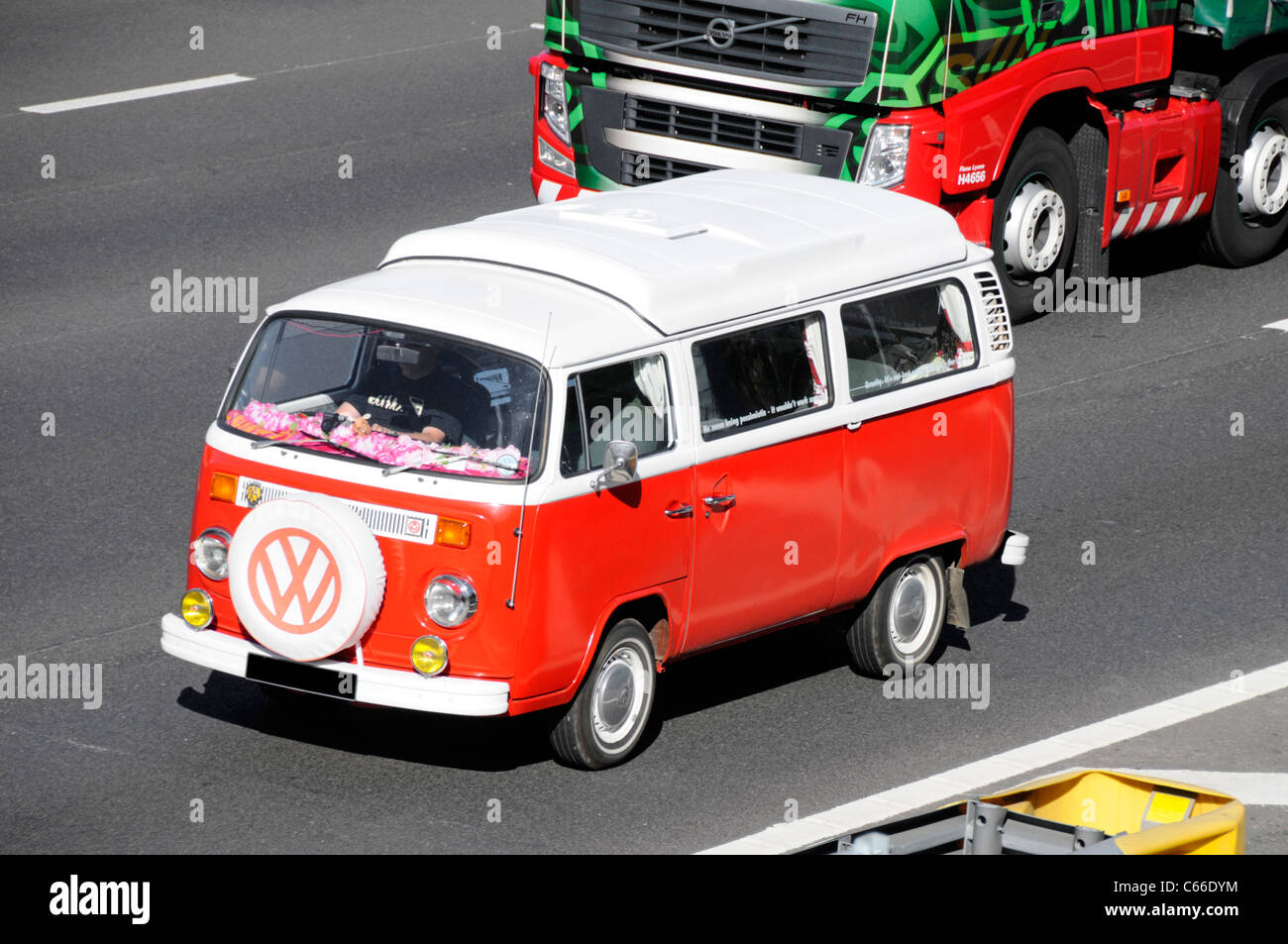 Classic Volkswagen VW Camper van on UK motorway (obscured numberplate) front mounted spare tyre with VW logo England UK Stock Photo