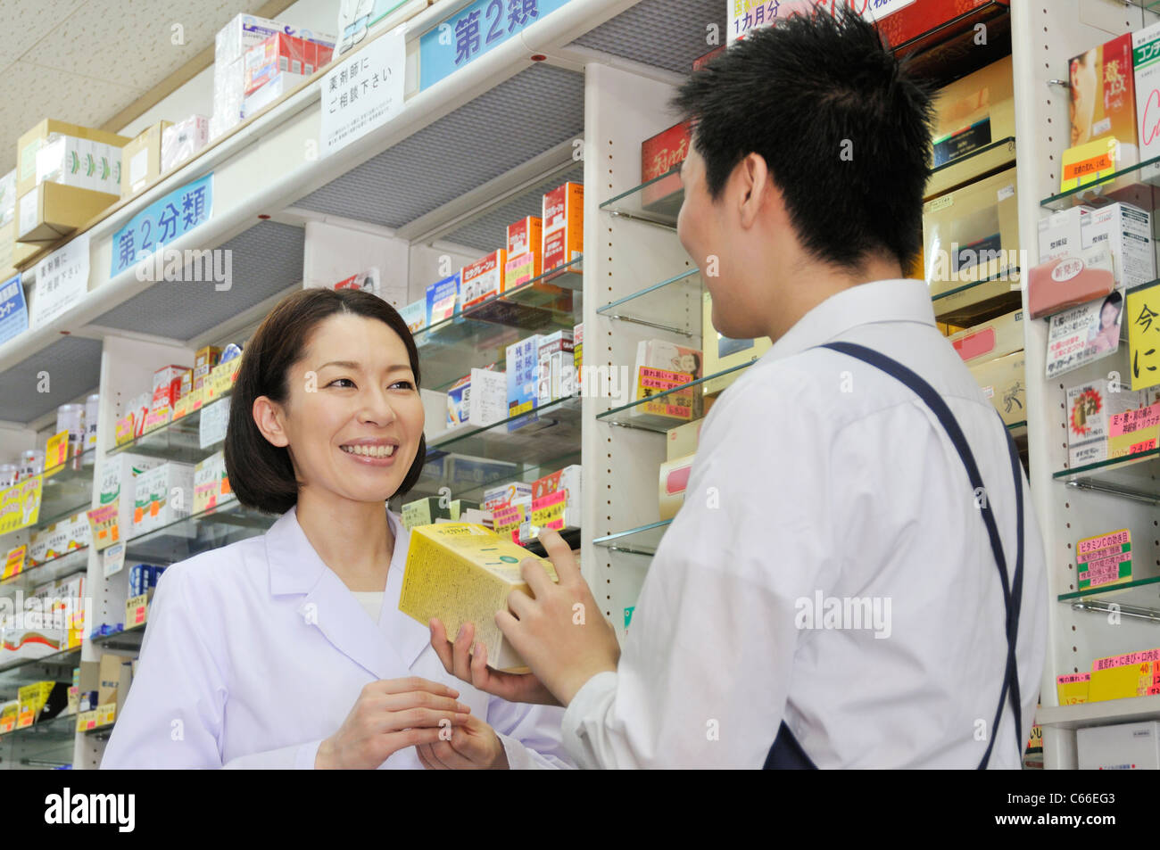 Pharmacist and Clerk of Drugstore Talking Stock Photo