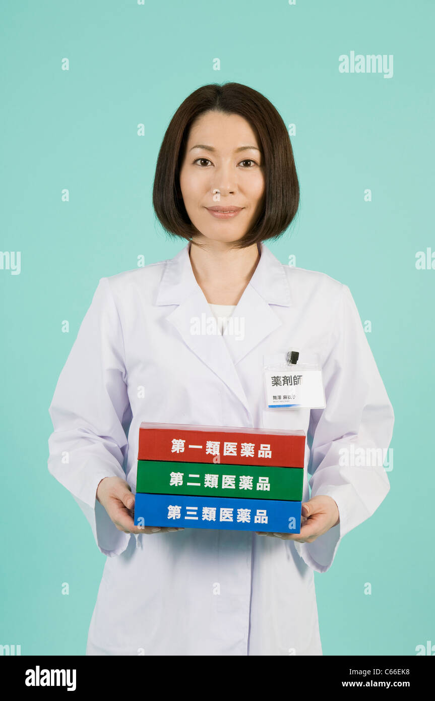Pharmacist Holding Boxes of Classification of OTC Drugs Stock Photo