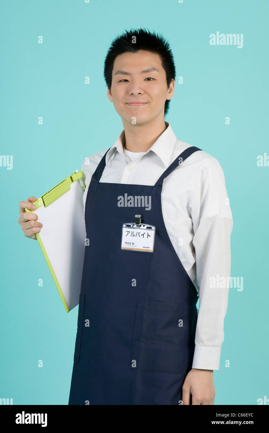 Clerk with Apron Holding Clipboard Stock Photo