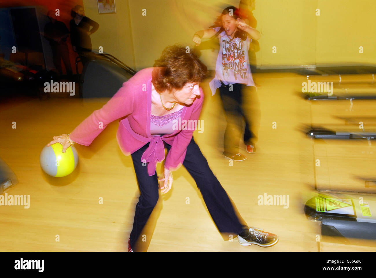 Elderly lady ten-pin bowling, Newcastle, Tyneside, UK. Stock Photo