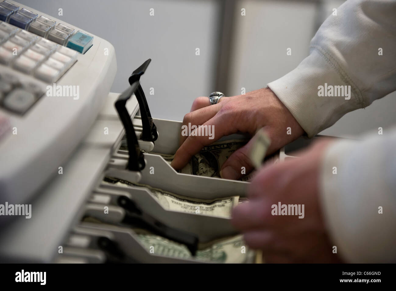 Cashier operating cash register Stock Photo