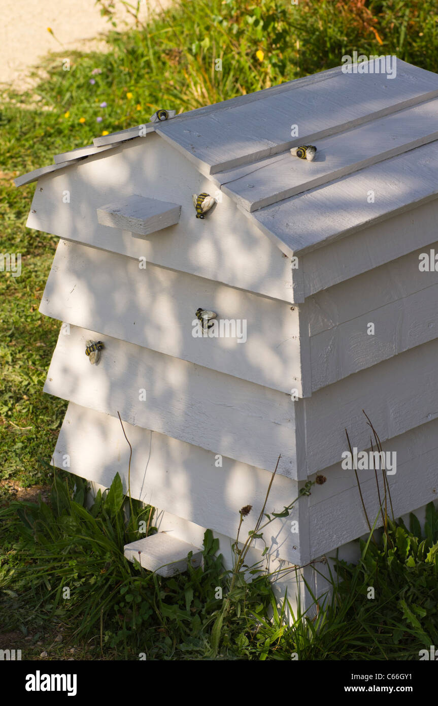 Wooden beehive with ornamental painted wooden bees Stock Photo Alamy