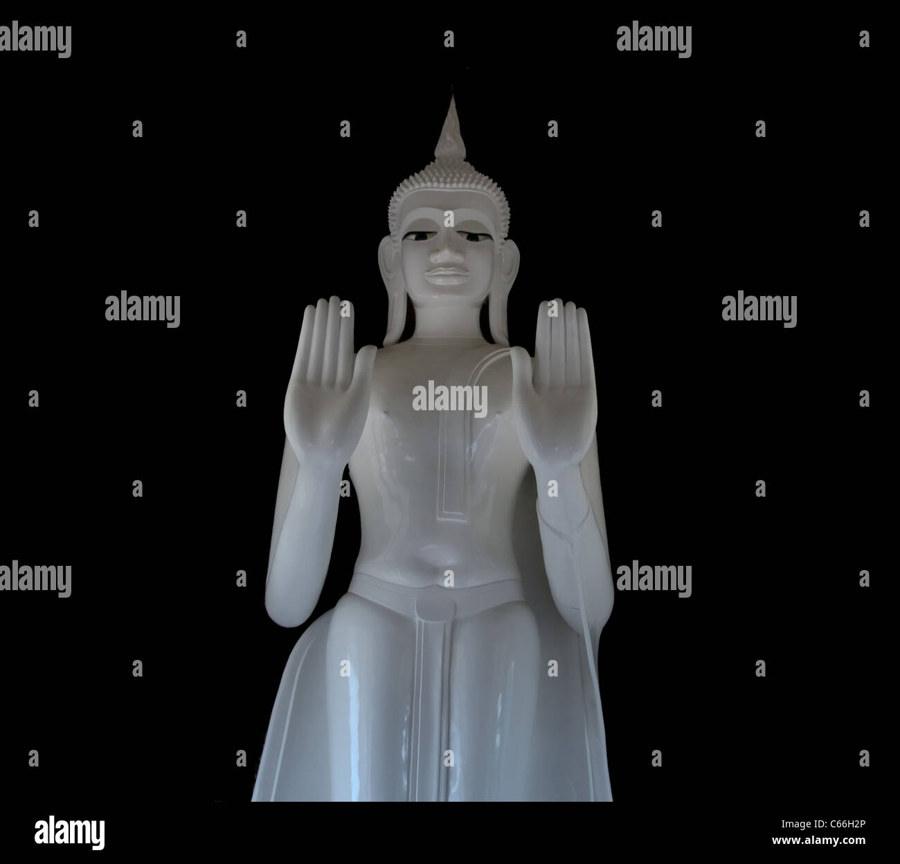 White Buddha Statue on a Black Background Stock Photo