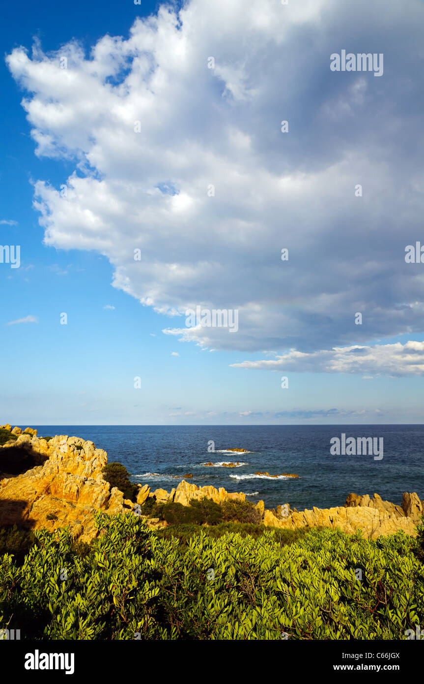 A view of the cost from Capo Comino, Sardegna, Italy, with big clouds at the horizon Stock Photo