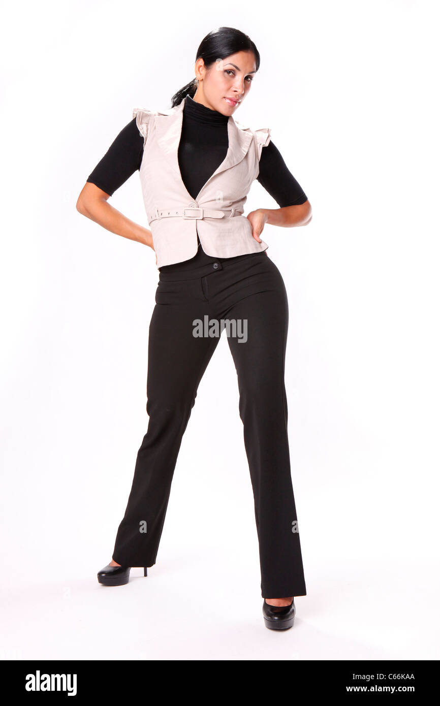 Young brunette in black slacks and cream vest Stock Photo
