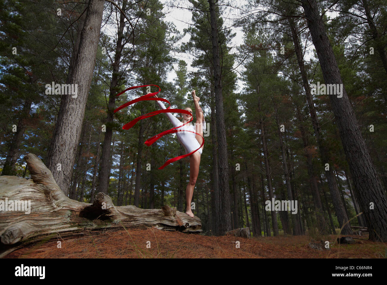 Dancer twirling ribbon in forest Stock Photo