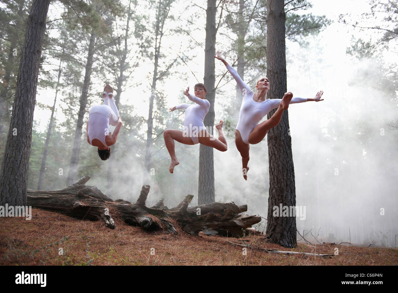 Dancers jumping in forest Stock Photo