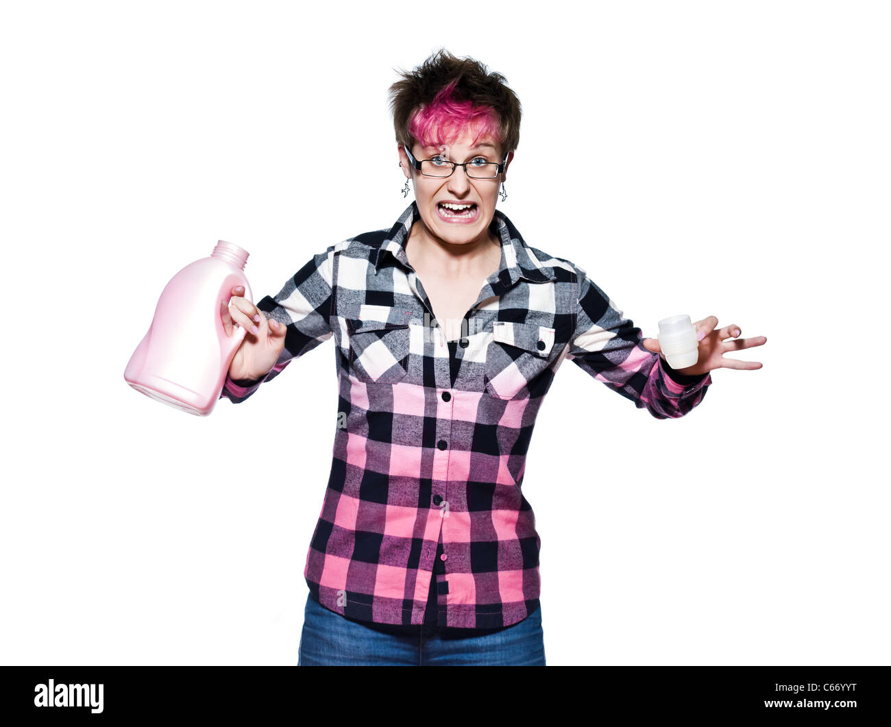 Portrait of a young frustrated woman holding detergent in studio on white isolated background Stock Photo