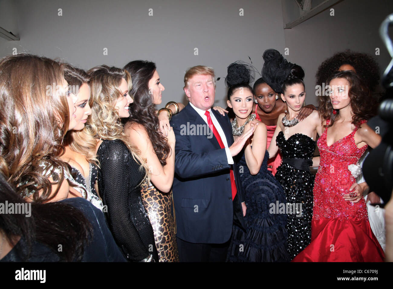Donald Trump and Famous Former Miss Universe Beauty Queens at the press conference for Donald Trump Miss Universe Beauty Queen Photo Shoot, Chelsea Piers, Pier 59, New York, NY July 27, 2011. Photo By: Andres Otero/Everett Collection Stock Photo
