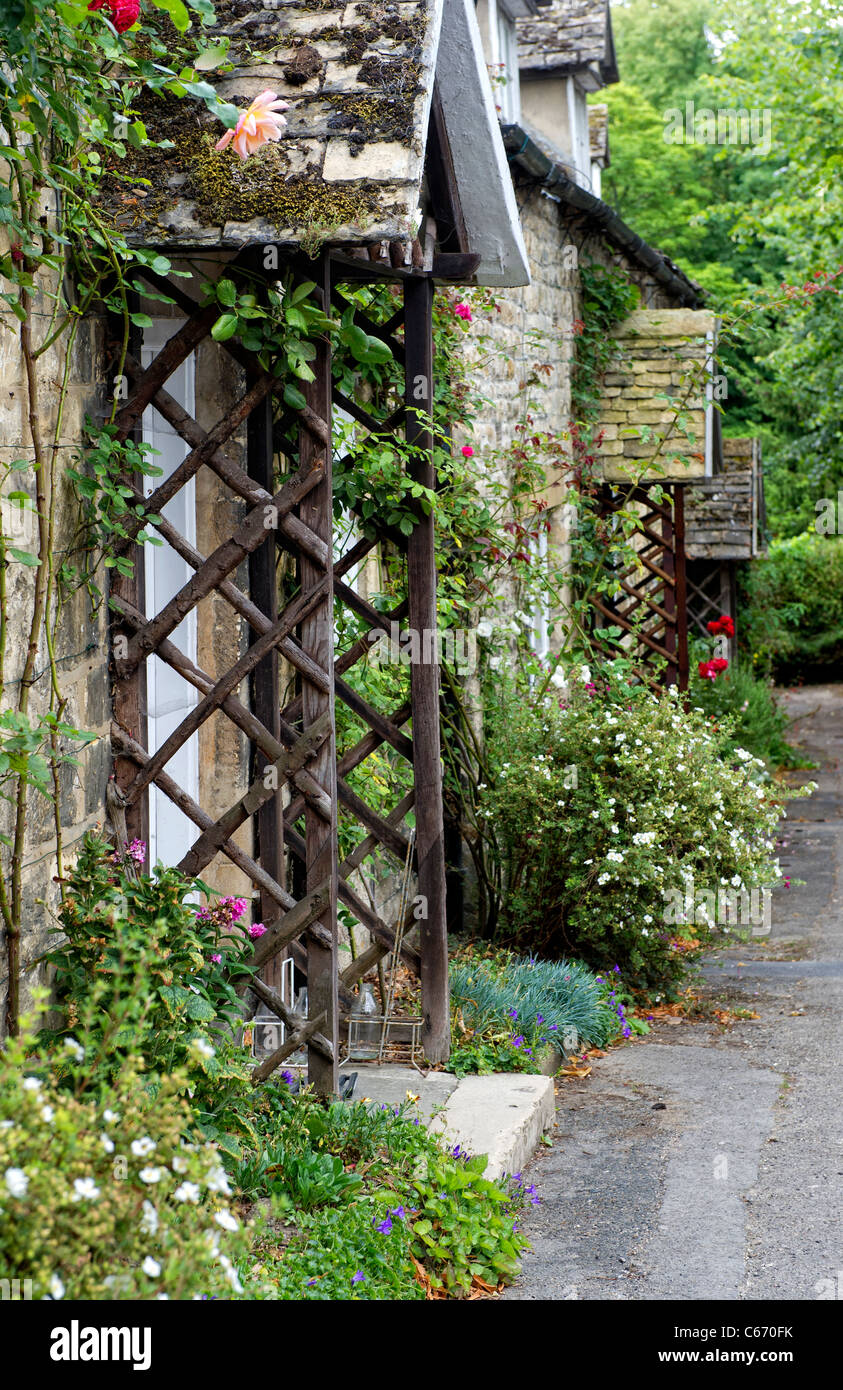 Trellis around the door of a pretty Cotswold cottage in Gloucestershire Stock Photo