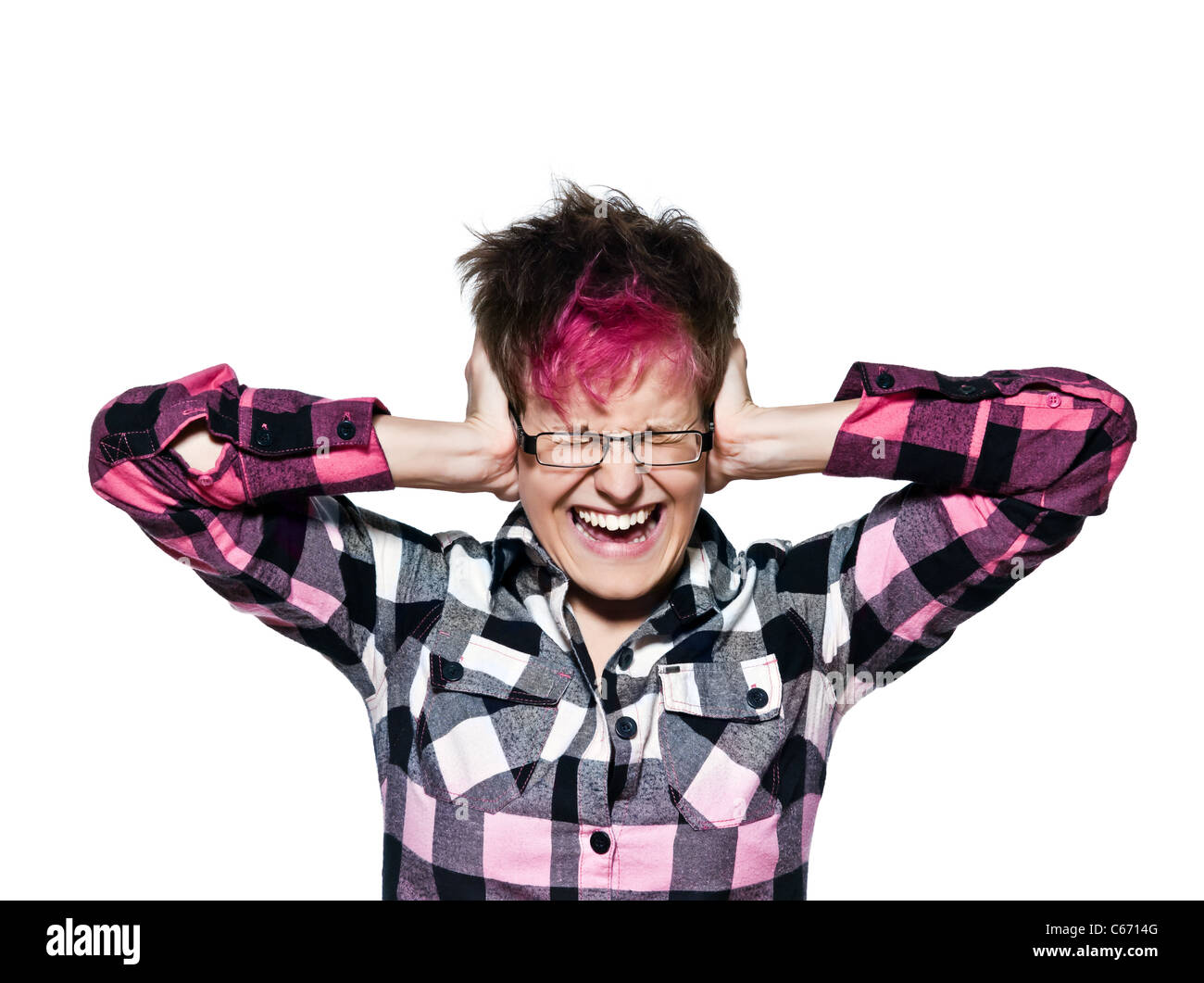 Portrait of a cool young woman screaming while covering ears isolated on white background Stock Photo