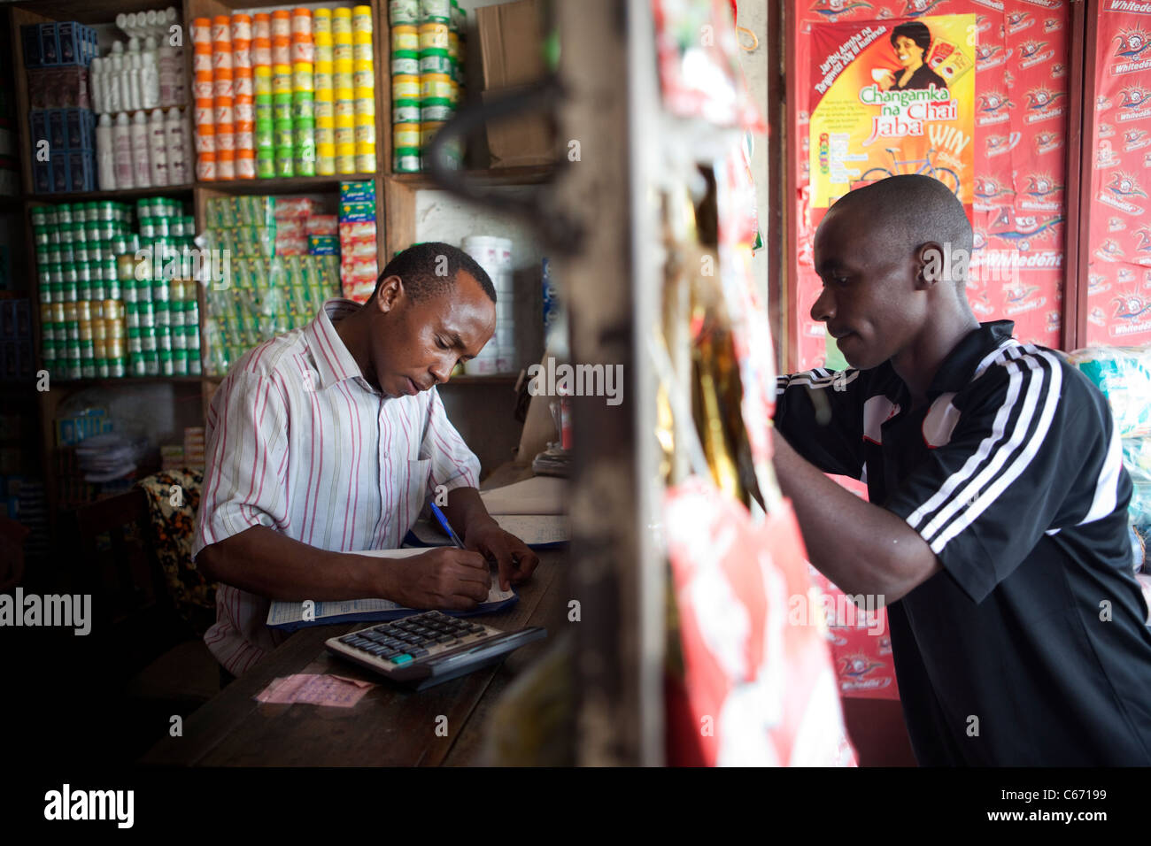 A customer visits a street shop in Dar es Salaam, Tanzania, East Africa Stock Photo