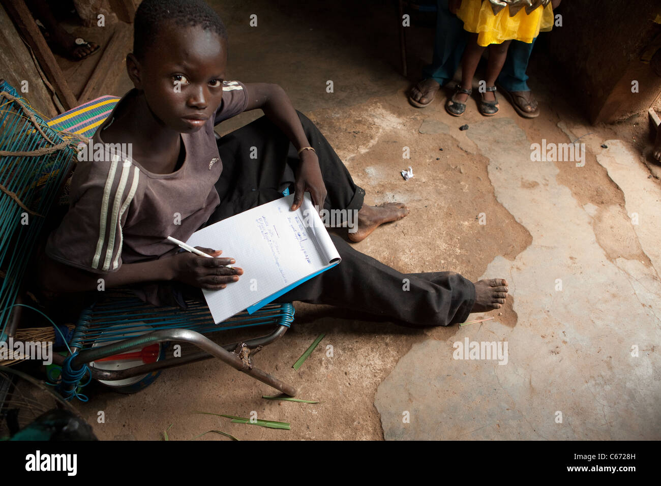 A boy does school work at home in a slum in Bamako, Mali, West Africa. Stock Photo