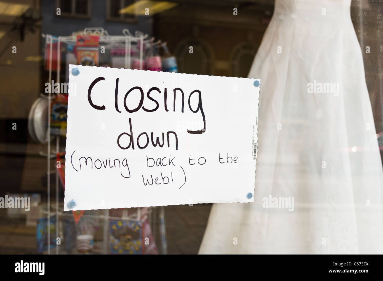 Closing Down notice in English shop window showing change of business strategy Stock Photo