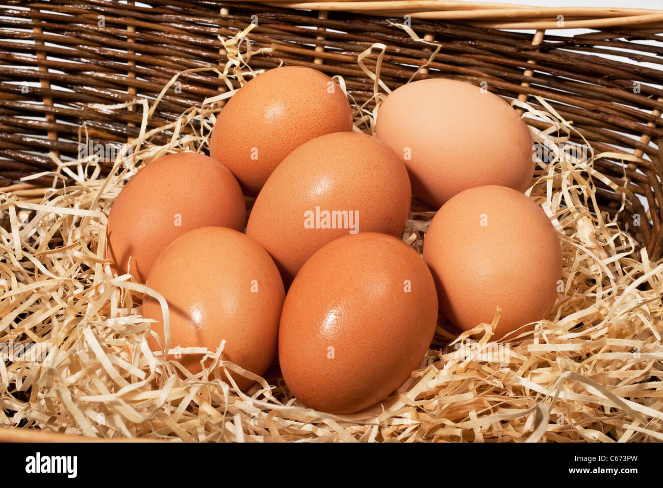 Six, half a dozen, hens eggs in a basket Stock Photo