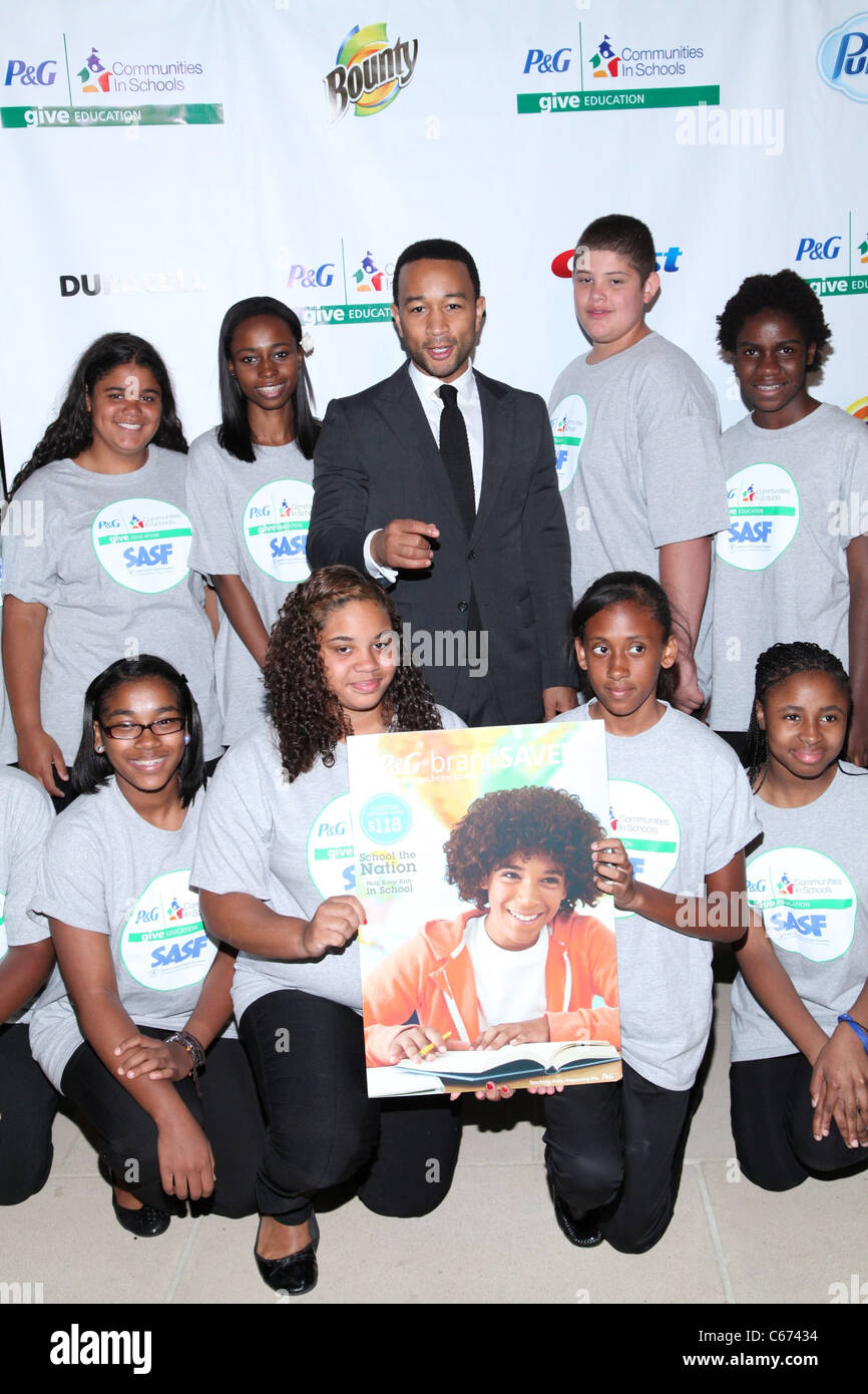 John Legend, members of SASF Champions Club Chorus at the press conference for GIVE Education Campaign Launch, IAC Building, New York, NY July 19, 2011. Photo By: Andres Otero/Everett Collection Stock Photo