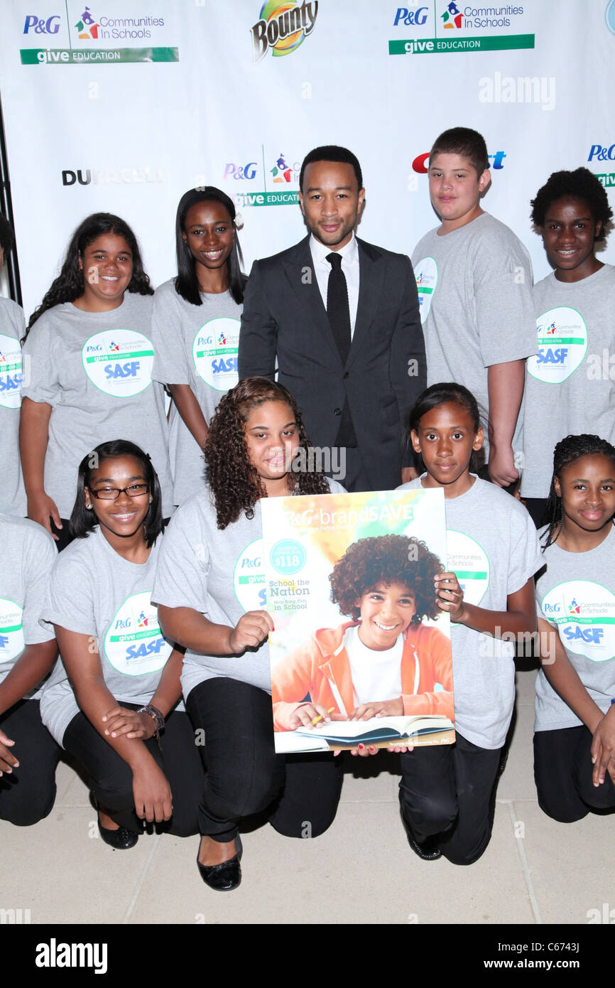 John Legend, members of SASF Champions Club Chorus at the press conference for GIVE Education Campaign Launch, IAC Building, New York, NY July 19, 2011. Photo By: Andres Otero/Everett Collection Stock Photo