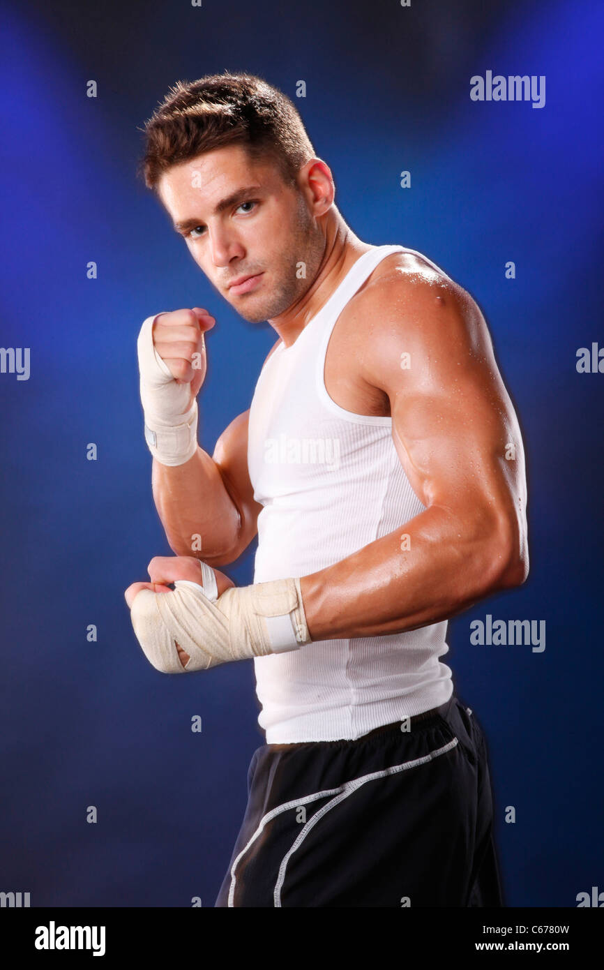 Toned boxer workng with hand wraps Stock Photo