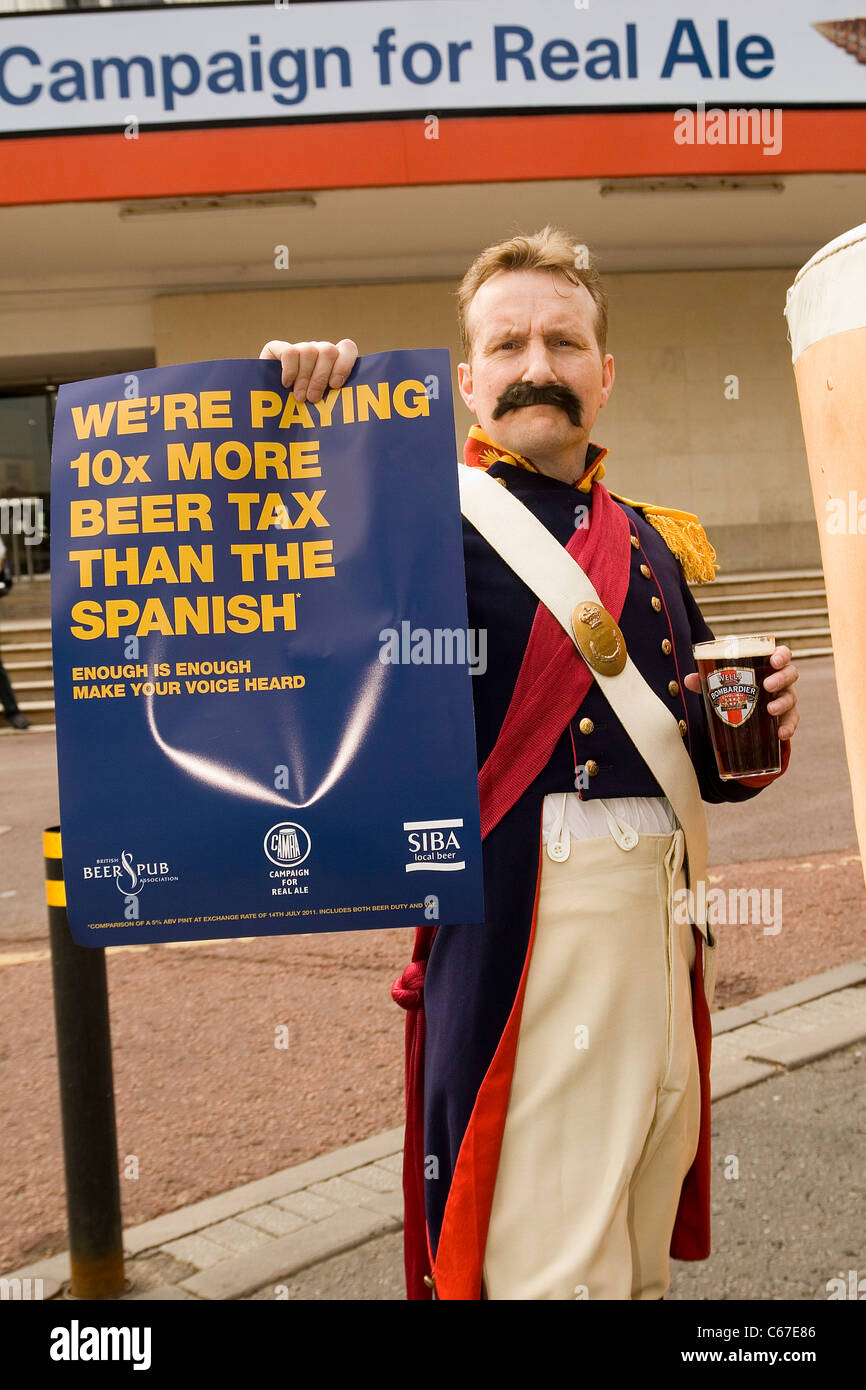 Campaign for real Ale festival in London with mascot holding poster complaining of tax levy on British beer Stock Photo
