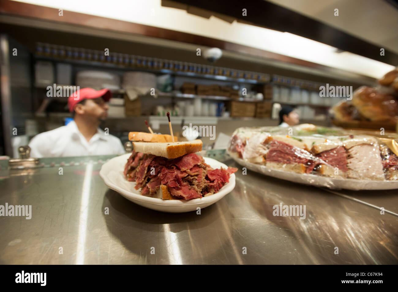 Pastrami sandwich awaits pickup by waitperson at the grand opening of