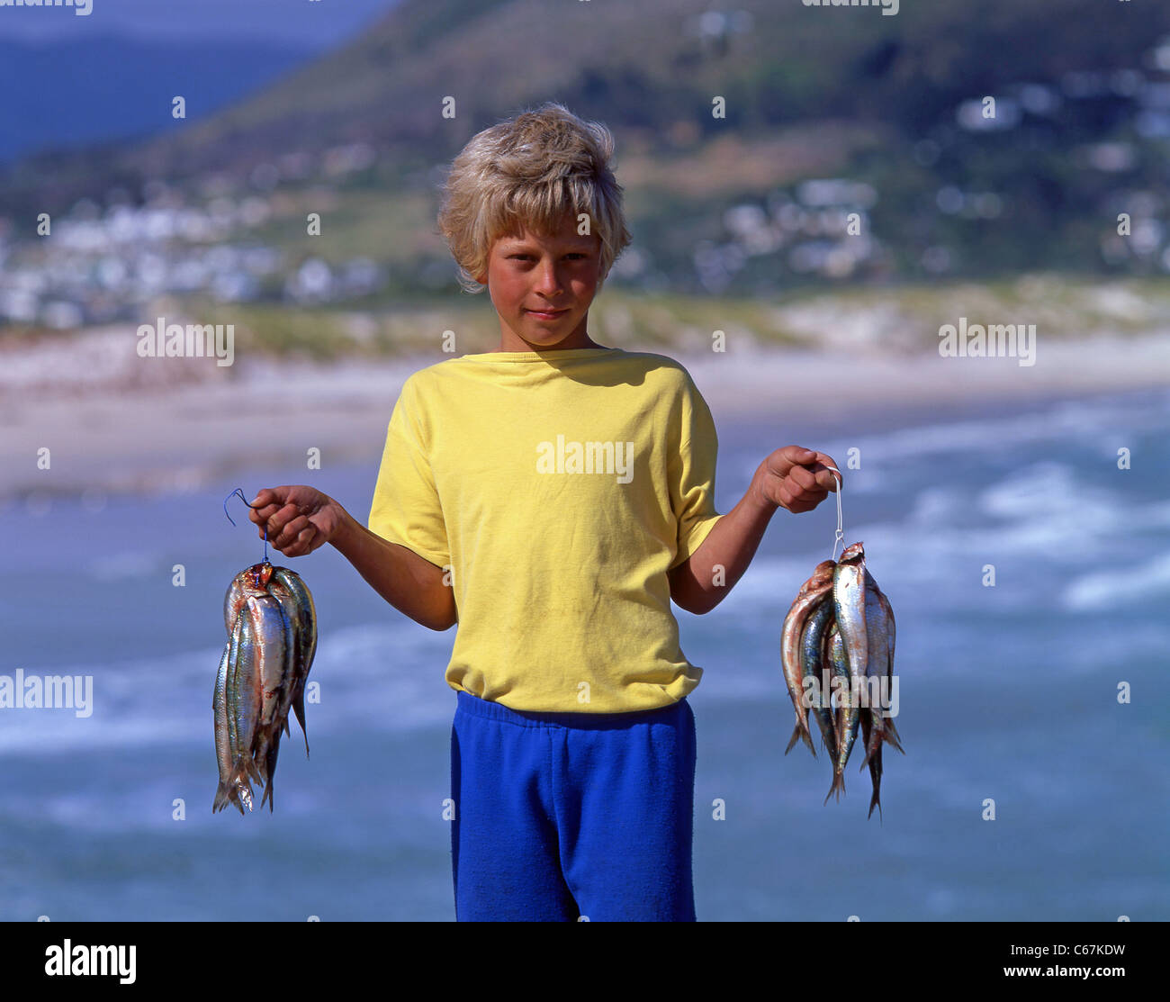 Young boy with fish catch, Hout Bay, Cape Town, Cape Peninsula, Western Cape, Republic of South Africa Stock Photo