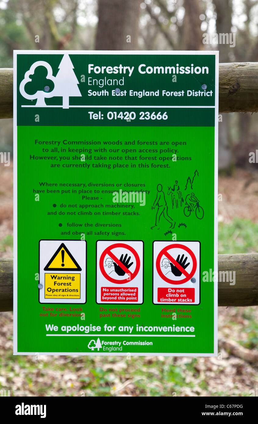 Forestry Commission Forest Operations Warning Sign fence trees No access Tree Felling polite notice information Stock Photo