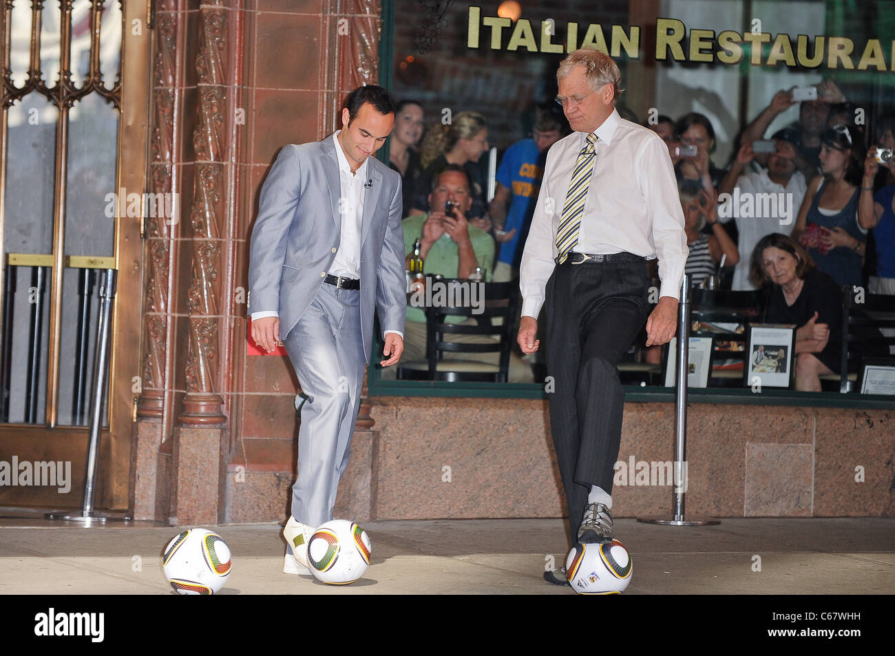 Professional soccer player Landon Donovan, David Letterman, perform skit in front of the Ed Sullivan Theater out and about for CELEBRITY CANDIDS - TUESDAY, , New York, NY June 29, 2010. Photo By: Ray Tamarra/Everett Collection Stock Photo