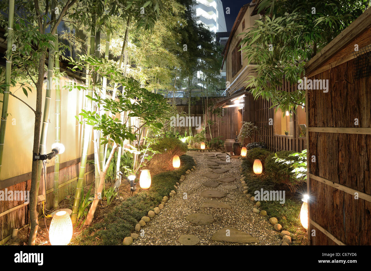 Lit gravel walkway at a Japanese Restaurant Stock Photo