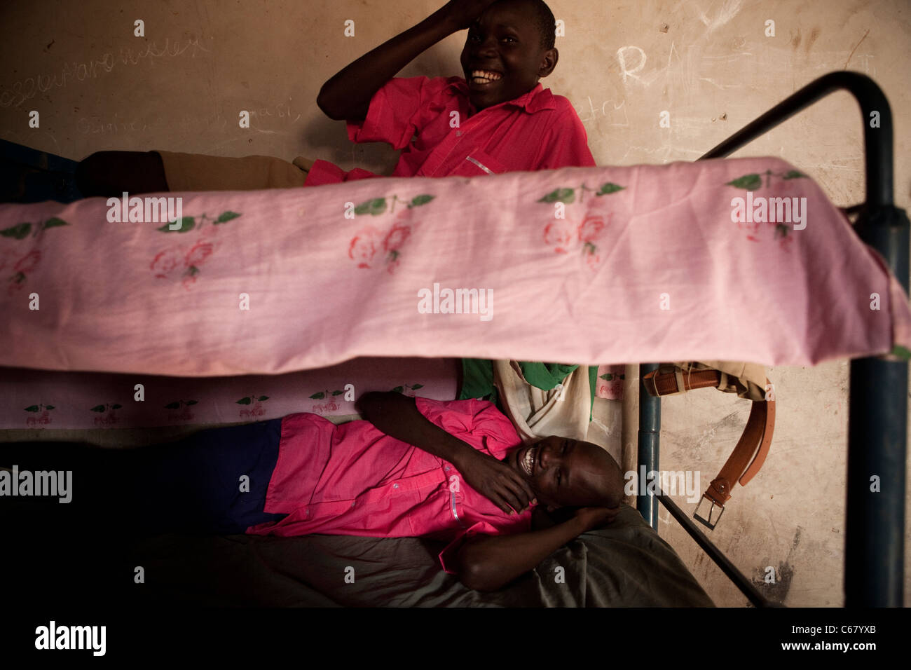 School boys lay in their bunk beds in a dormitory in Amuria, Uganda, East Africa. Stock Photo