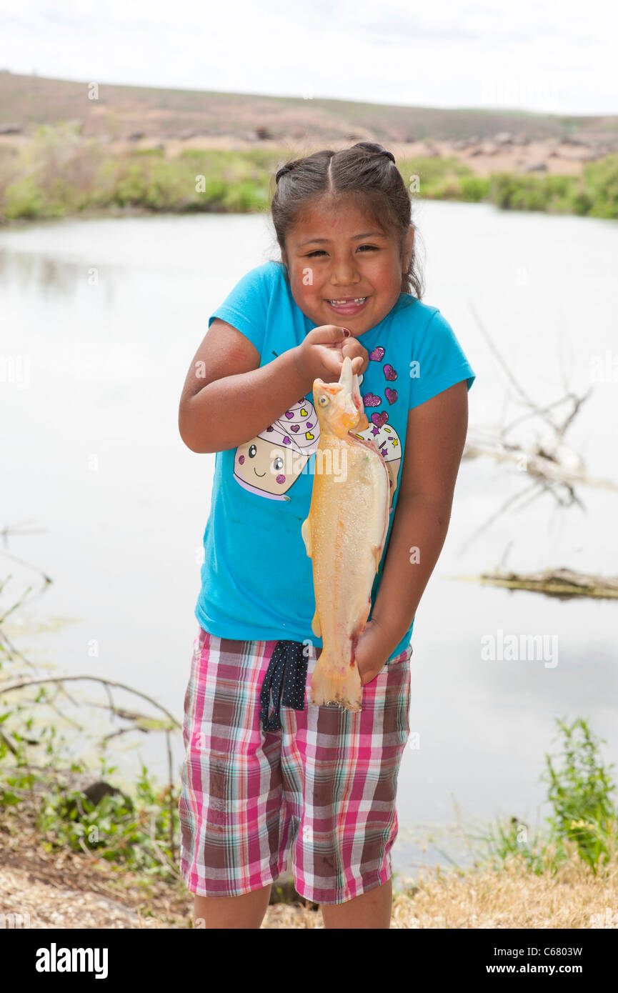 A happy little mexican girl holding a fish Stock Photo
