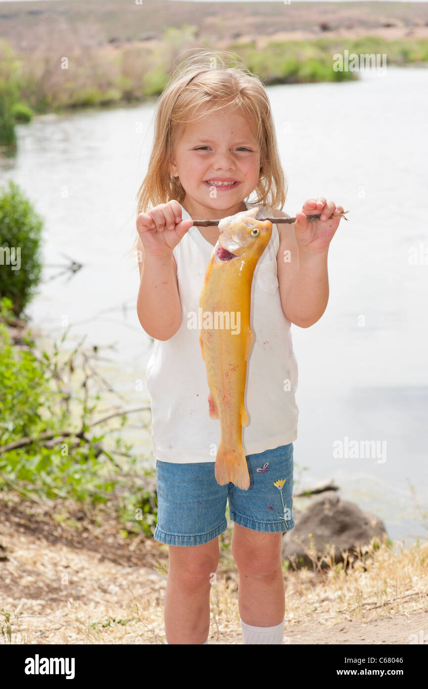 Happy little girl holding fish hi-res stock photography and images - Alamy