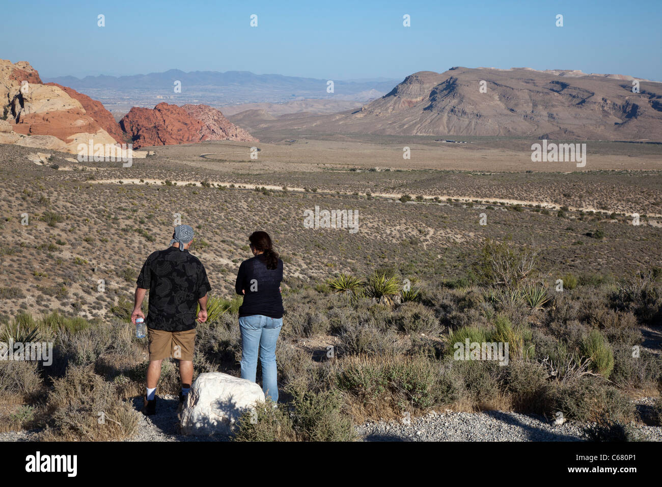 Las Vegas, Nevada - A couple looks over Red Rock Canyon towards the city of Las Vegas in the valley below. Stock Photo