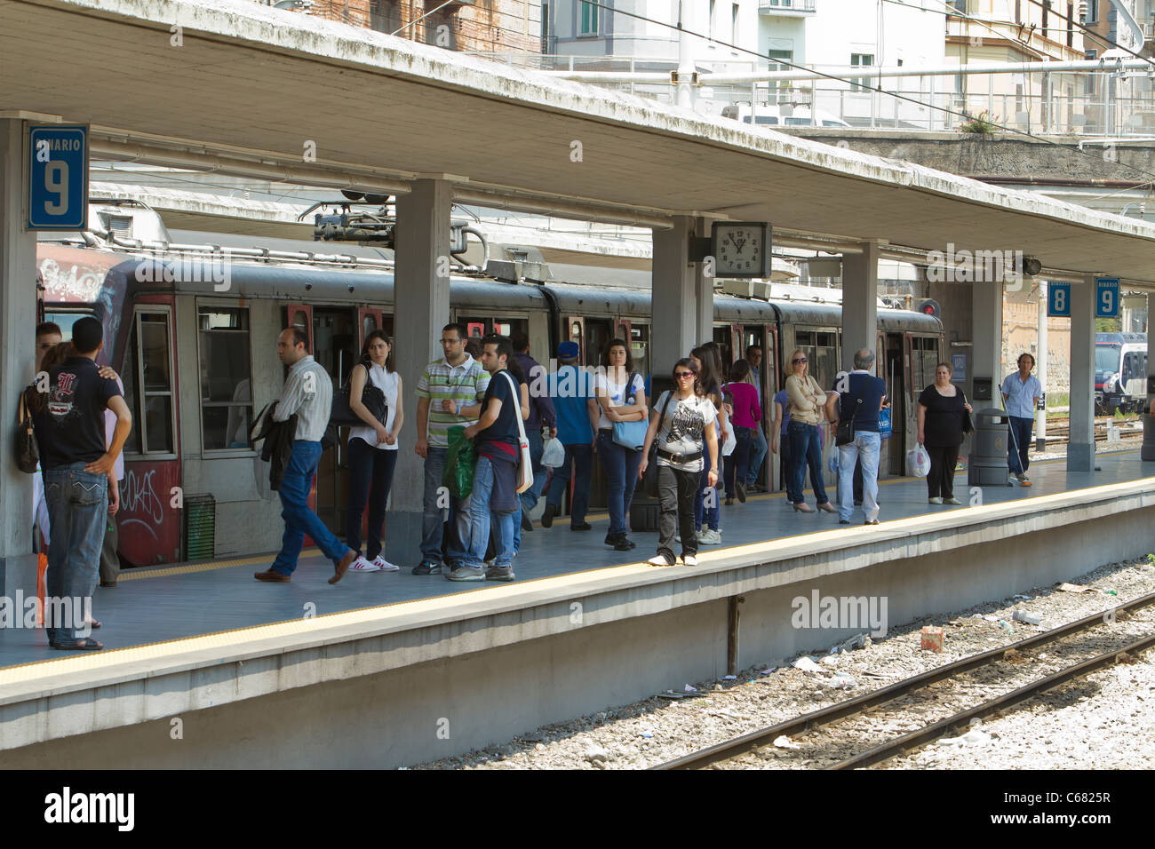 Naples Italy train station with passengers on loading deck ready to