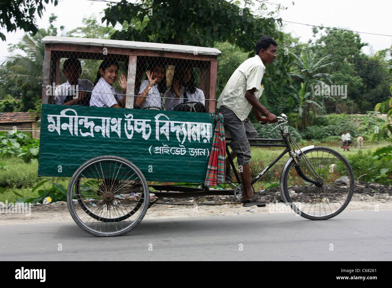 Girls travel to school in tricycle rickshaw pedal bus West Bengal