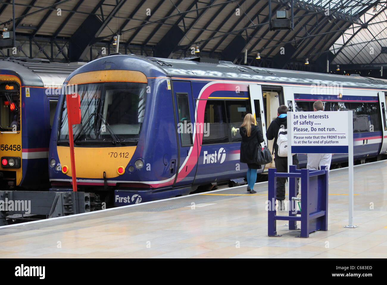 Diesel Multiple unit trains in Glasgow Queen Street station with passengers about to board the nearer train. Stock Photo