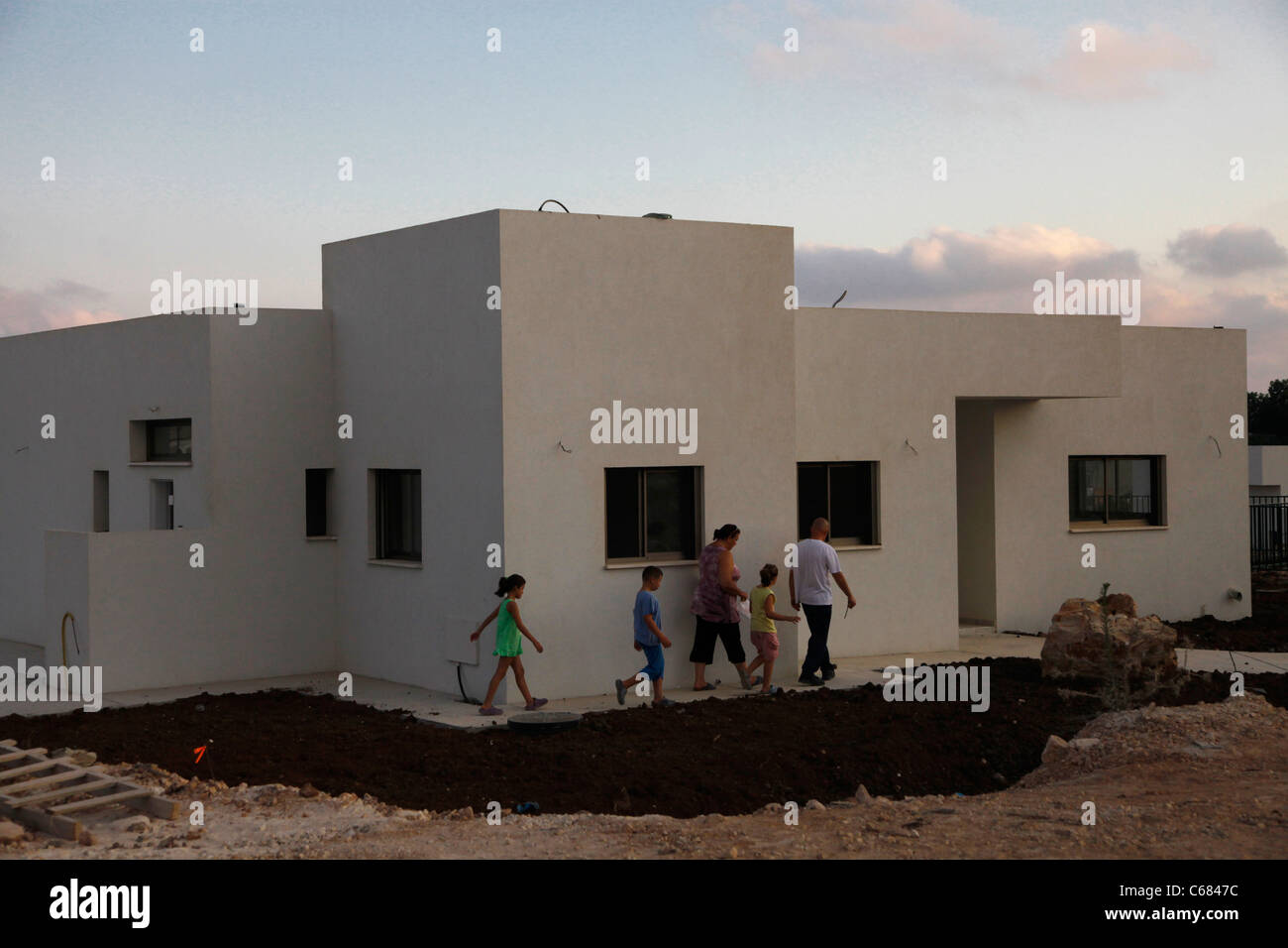 Israeli family walking around their new home in Kibbutz Hanita located
