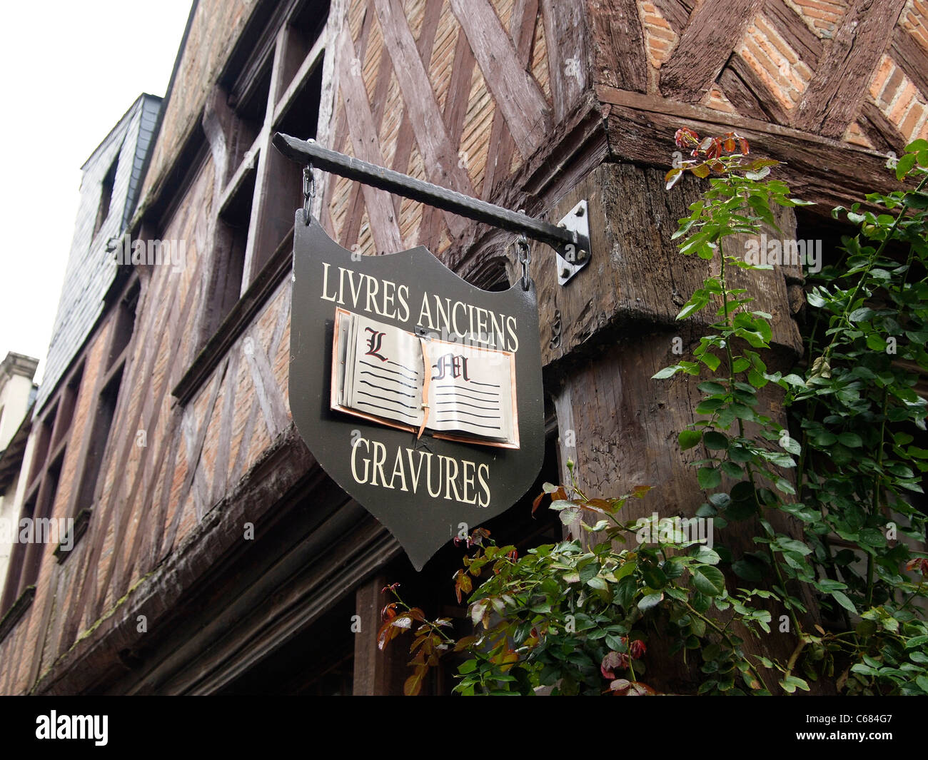 Medieval half timbered building with antique bookshop sign, Chinon, Loire valley, France Stock Photo